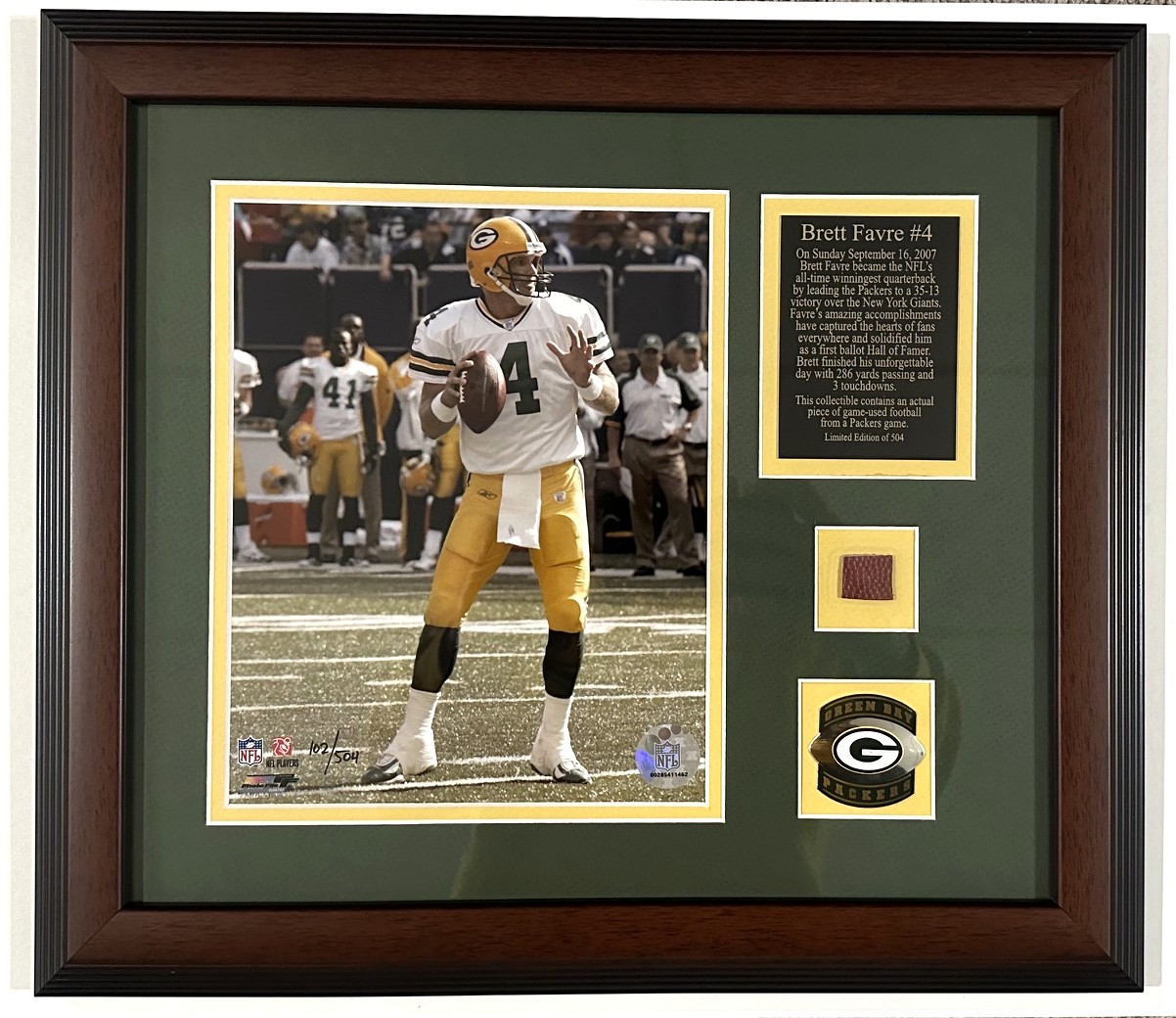 BRETT FAVRE FRAMED HIGHLAND MINT PACKERS 8X10 PHOTO INCLUDING FOOTBALL PIECE WITH 24KT GOLD MEDALLION